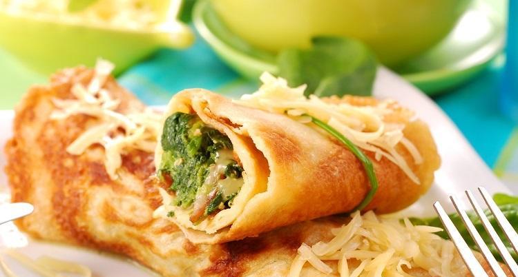 Rolled pancakes stuffed with the  spinach