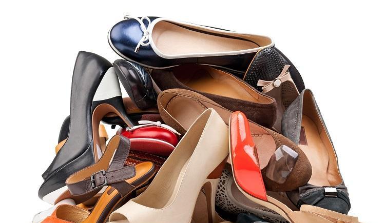 Pile of various female shoes isolated over white, with clipping path